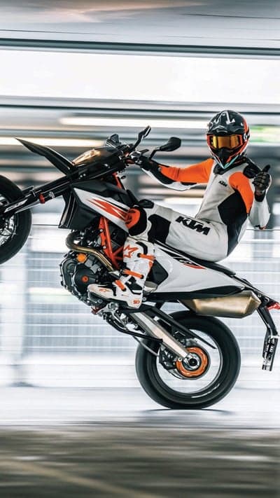 Motorcyclist performing a wheelie on a KTM bike