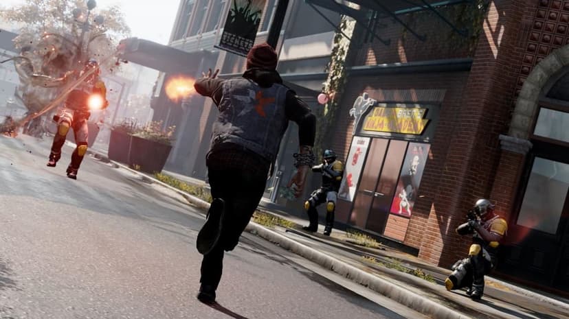 Delsin Rowe runs through a city street firing energy at armored D.U.P. soldiers in a bright, sunlit urban setting.