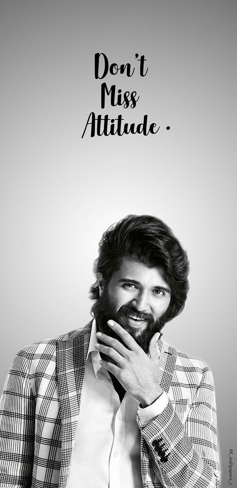 Vijay Deverakonda wearing a checkered blazer with "Don't Miss Attitude" text in a monochrome portrait.