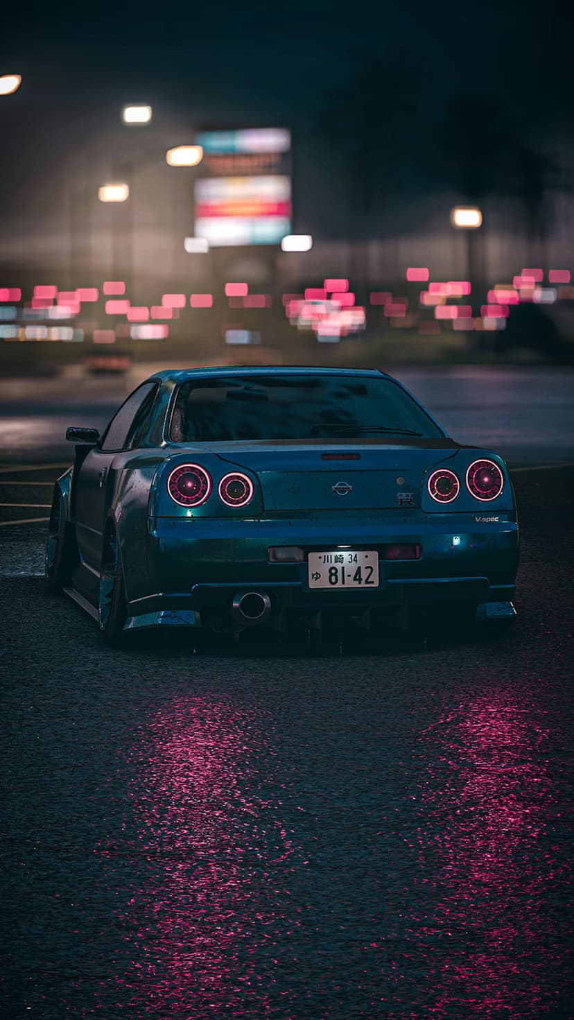 Teal Nissan R34 GT-R parked on a wet city street at night with glowing taillights and neon reflections.