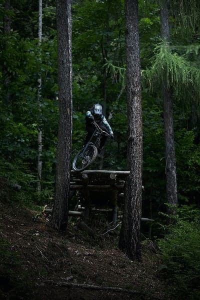 Downhill MTB Action Forest Ramp Vertical Background