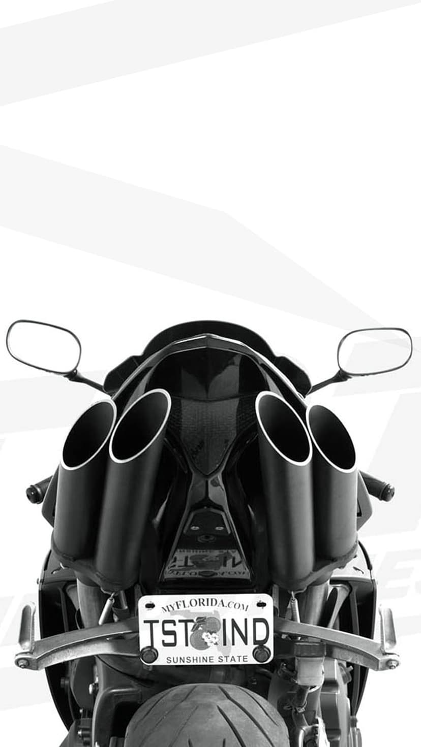 Black motorcycle rear featuring four exhaust pipes and a Florida license plate from a low-angle perspective.
