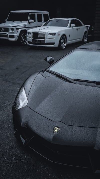 Rain Drenched Elite Cars Mobile Wallpaper Background