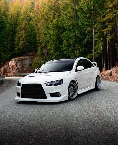 White Mitsubishi Evo Forest Road Mobile Wallpaper