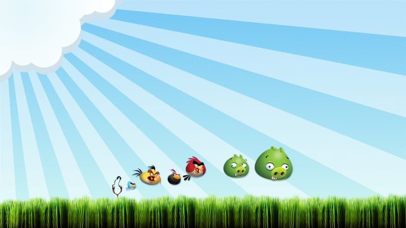 Red, Chuck, and Bomb birds with Green Pigs floating over green grass under a blue sunburst sky with a cloud.