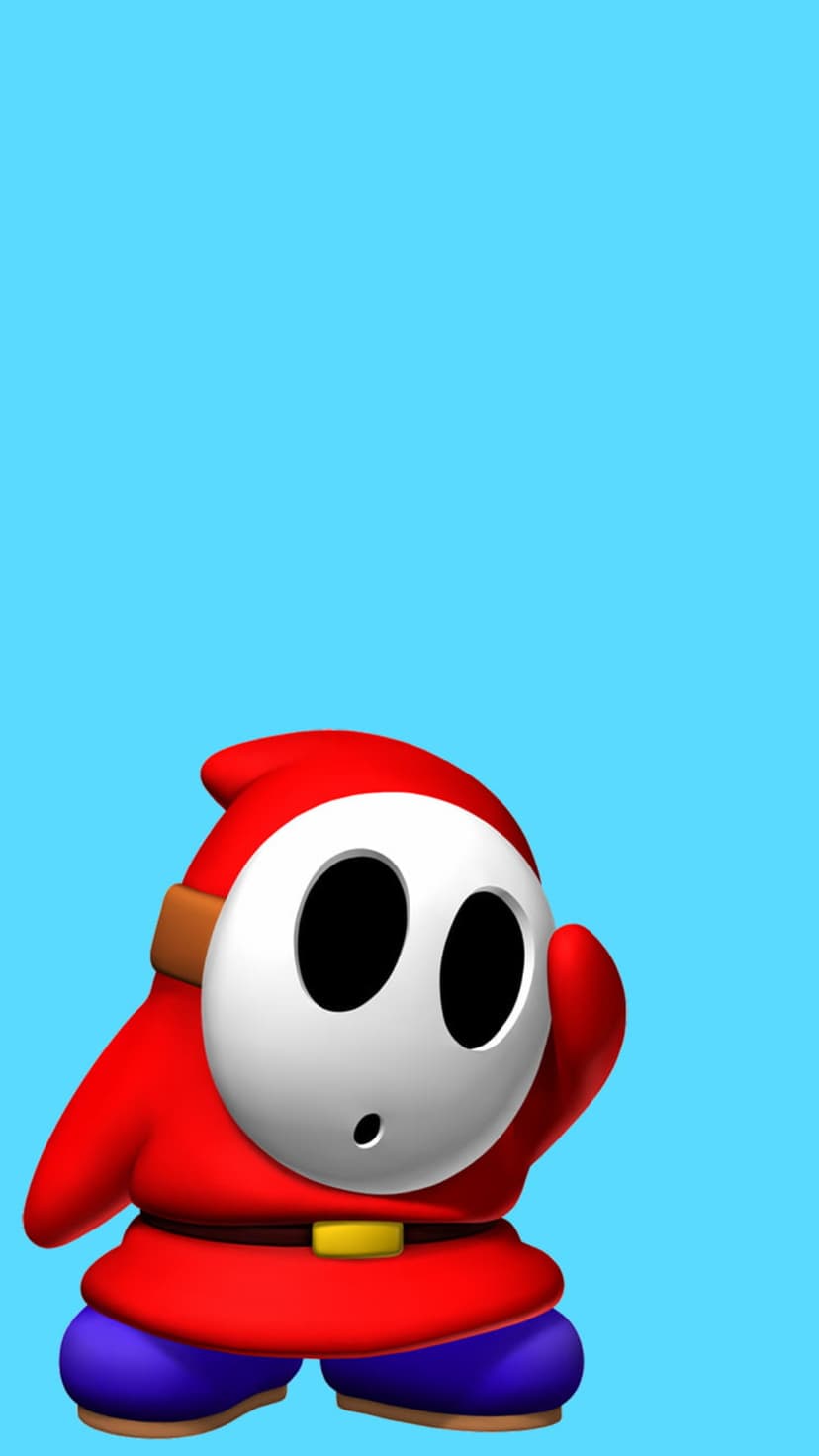 Shy Guy wearing a red robe and white mask stands against a bright blue backdrop while gesturing toward its face.