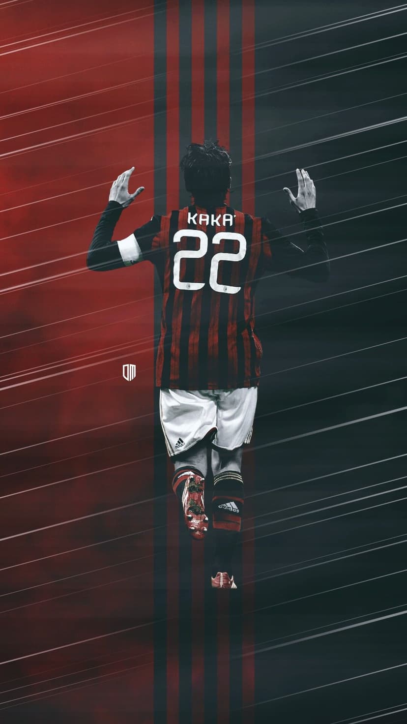 Kaká in his number 22 AC Milan jersey raises his arms toward a striped red and black background in a back view.
