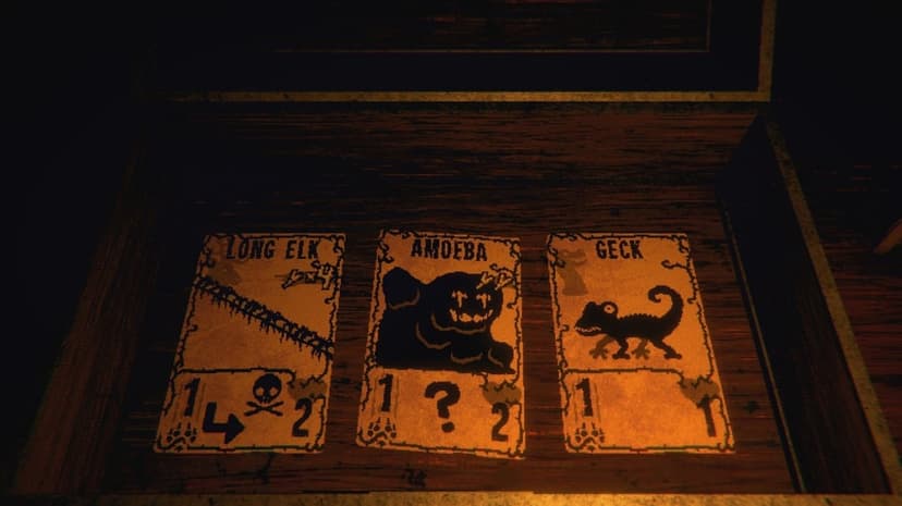 Three pixelated Inscryption game cards rest inside a dark wooden box under a dim, warm amber light.