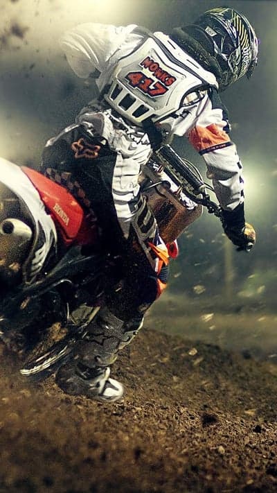 Motocross rider kicks up dirt during intense race