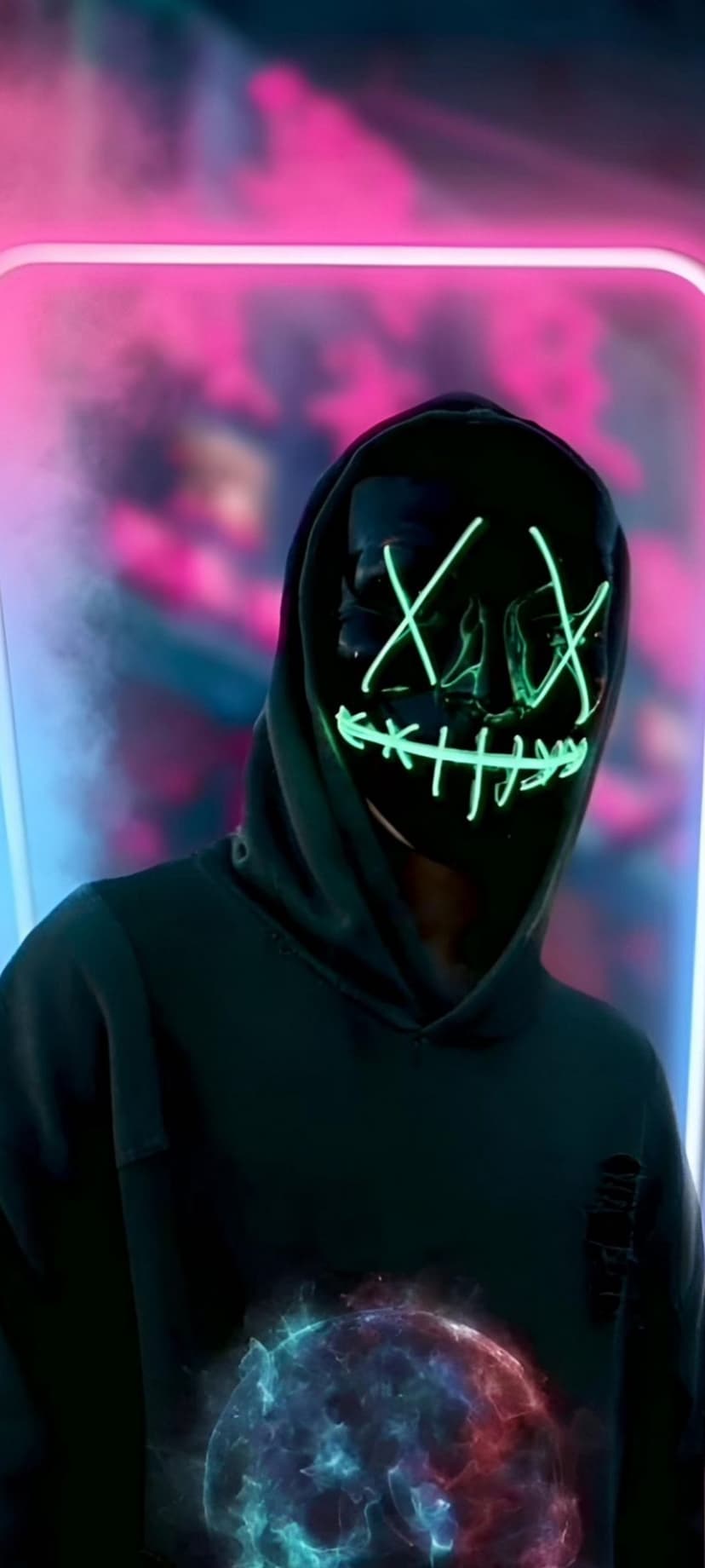 Person in a green LED mask and black hoodie stands near a swirling blue and red orb among pink neon smoke.