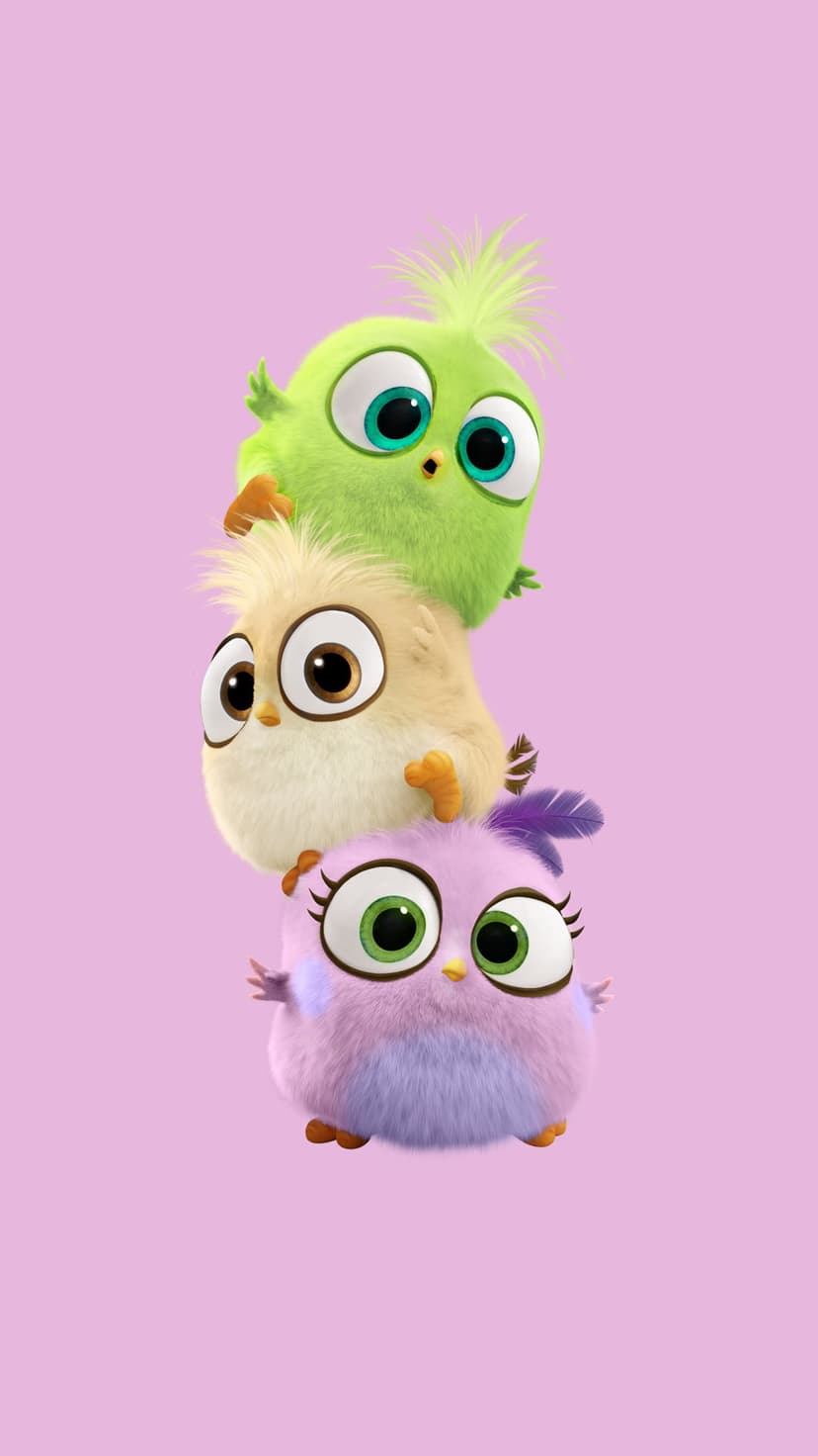 Three fuzzy round hatchlings in green, yellow, and lavender stacked vertically against a soft pink background.