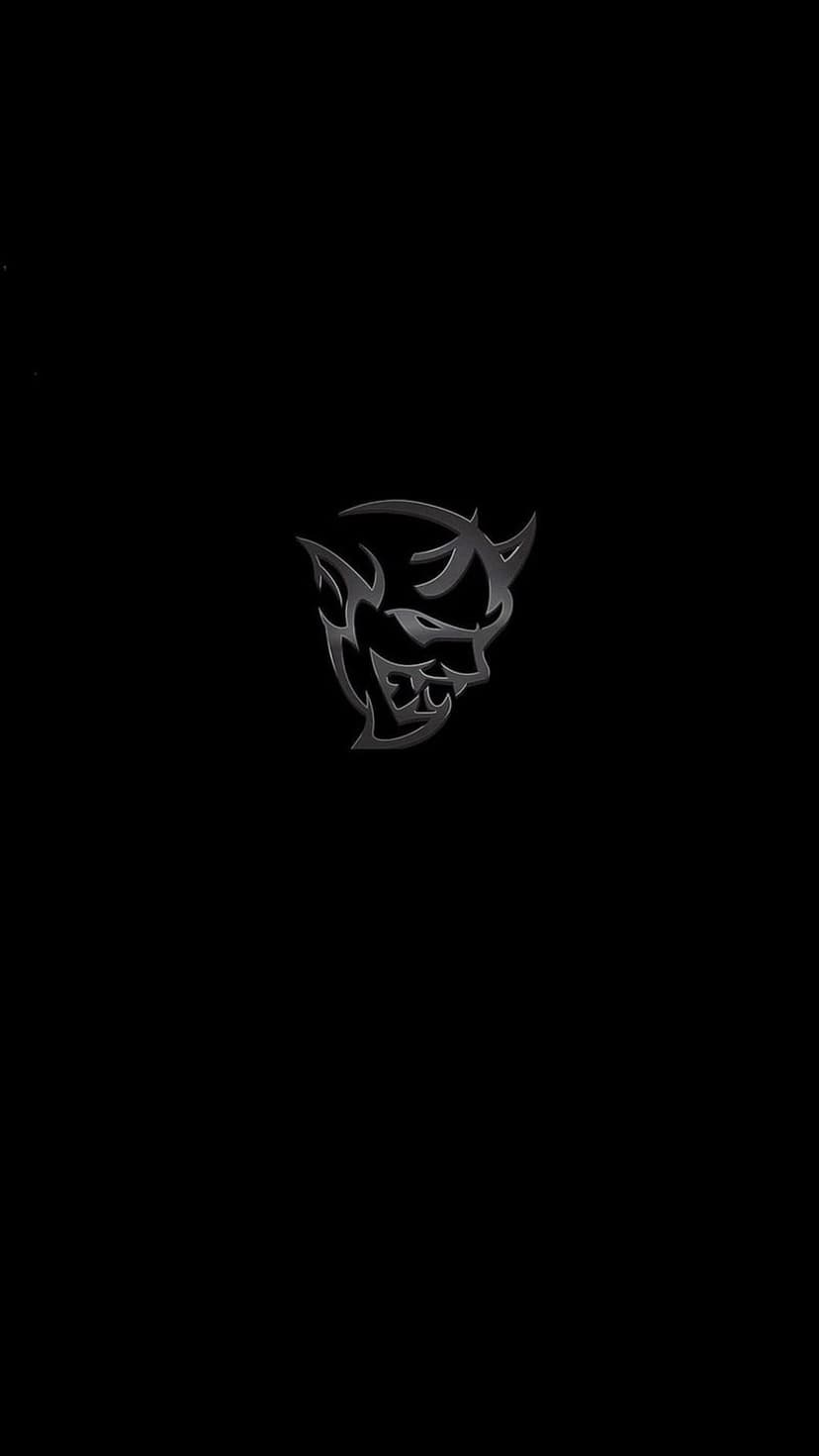 Silver metallic Demon car logo with horns centered on a black background for a vertical mobile phone screen.