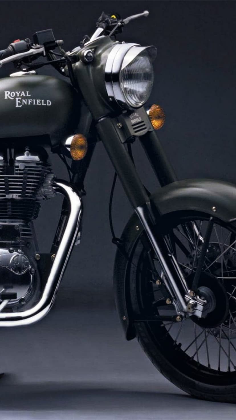 Royal Enfield motorcycle front featuring a chrome headlight, orange turn signals, and detailed engine casing.