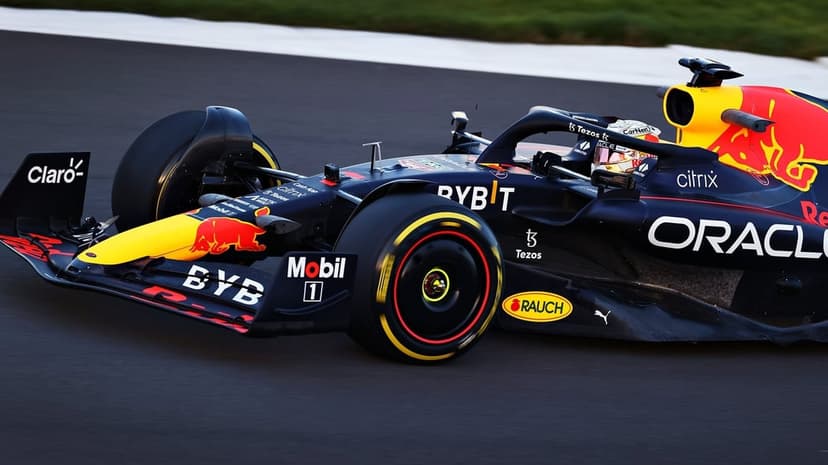 Red Bull Racing Formula 1 car with number one speeding on an asphalt track with motion-blurred wheels.