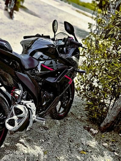 Sleek Black Sportbike & Green Foliage Phone Backdrop