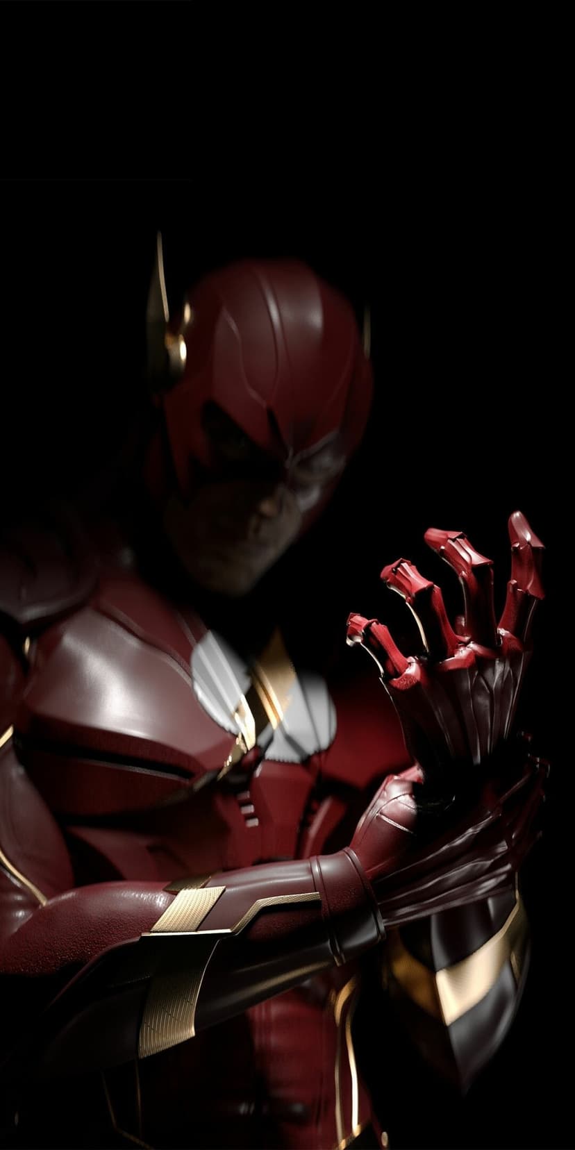 Armored red superhero in gold-trimmed plating gazes at his hand against a dark, high-contrast background.