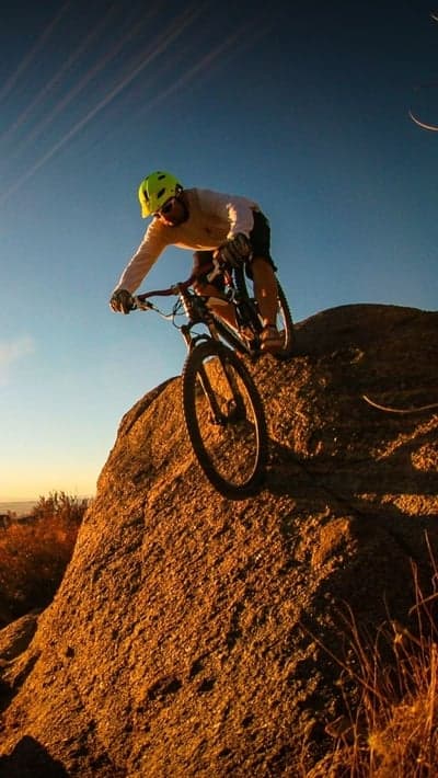 Golden Hour Downhill Mountain Biking Mobile Background