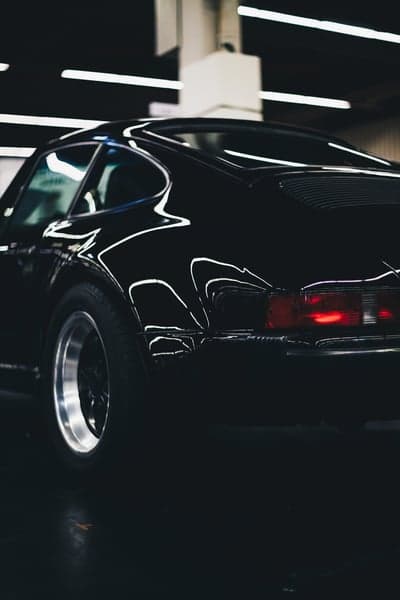 Sleek Black Porsche 911 Rear Close-up Phone Wallpaper