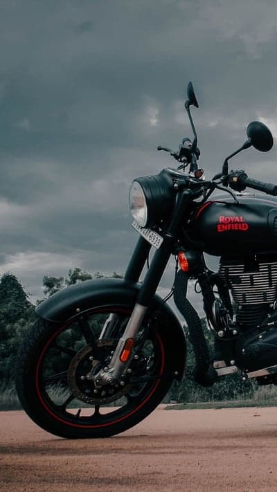 Black Royal Enfield Motorcycle Under Cloudy Skies
