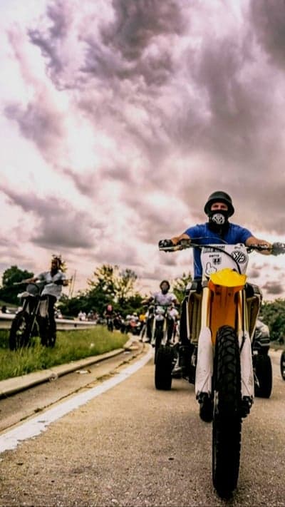 Biker Gathering Under Stormy Skies Mobile Wallpaper