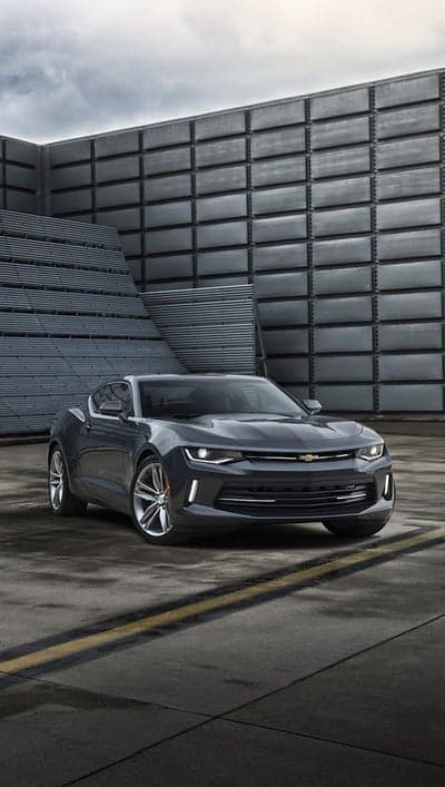 Dark Grey Chevrolet Camaro parked in modern industrial setting