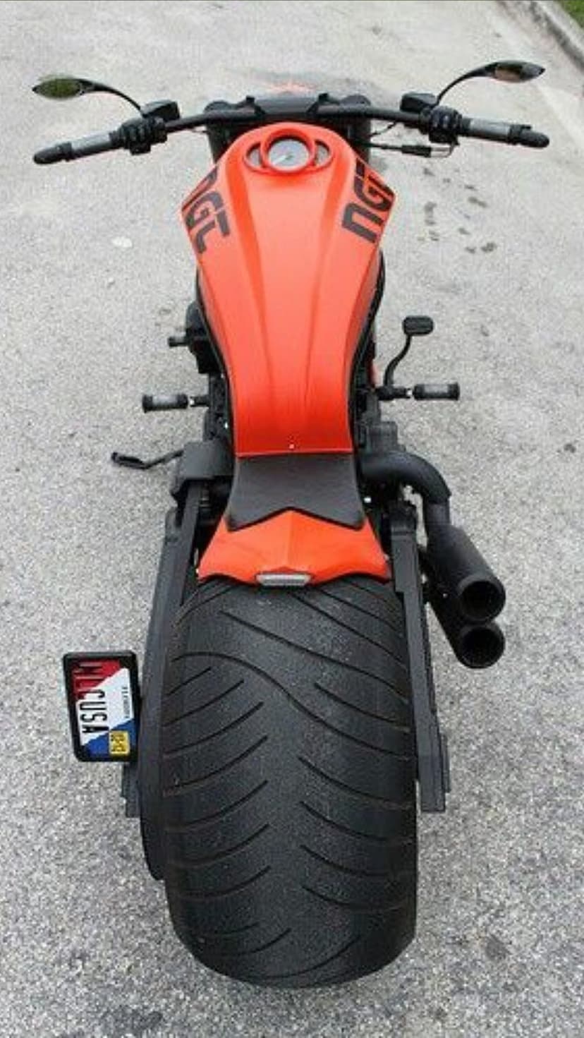 Orange Harley-Davidson Nightrod motorcycle with a wide rear tire and dual exhaust viewed from a top-down angle.