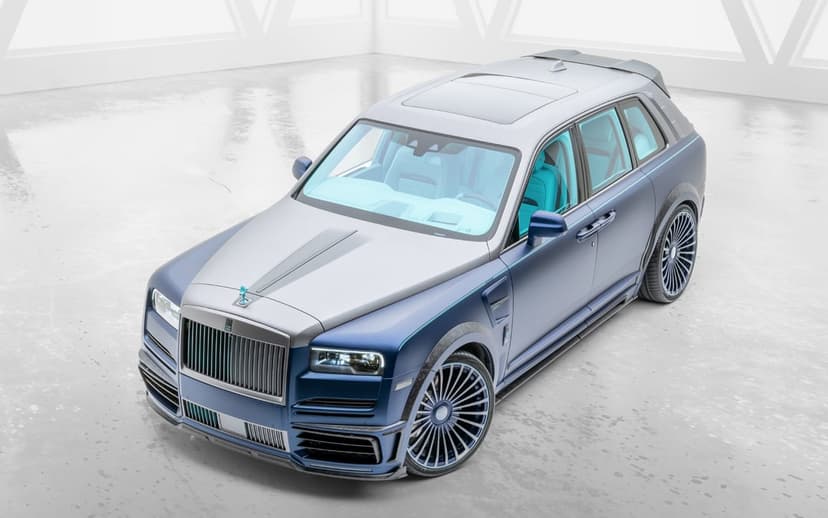 Custom blue and silver Rolls-Royce Cullinan with a cyan interior in a minimalist white studio environment.