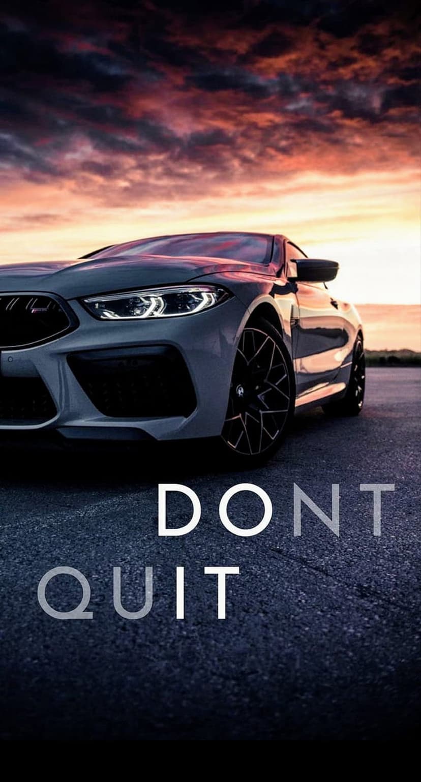 Sleek sports car parked on an asphalt road at sunset with the bold text Don't Quit overlaid in the center.