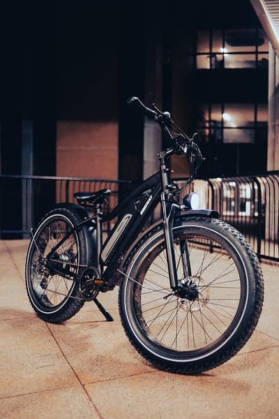 Black Fat Tire Electric Bike Parked Outdoors at Night