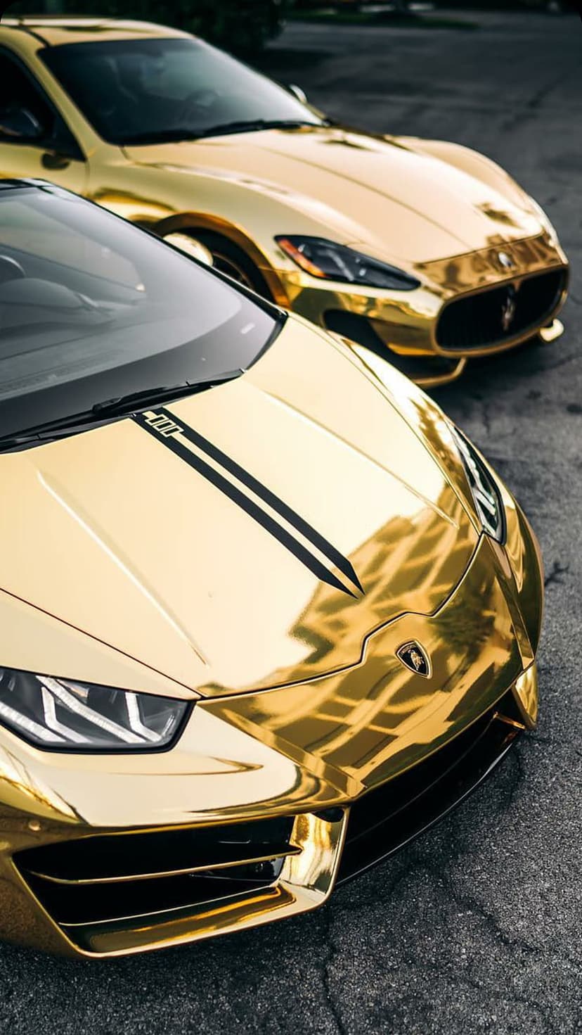 Gold Maserati and Lamborghini supercars with metallic chrome wraps parked together on a paved surface.