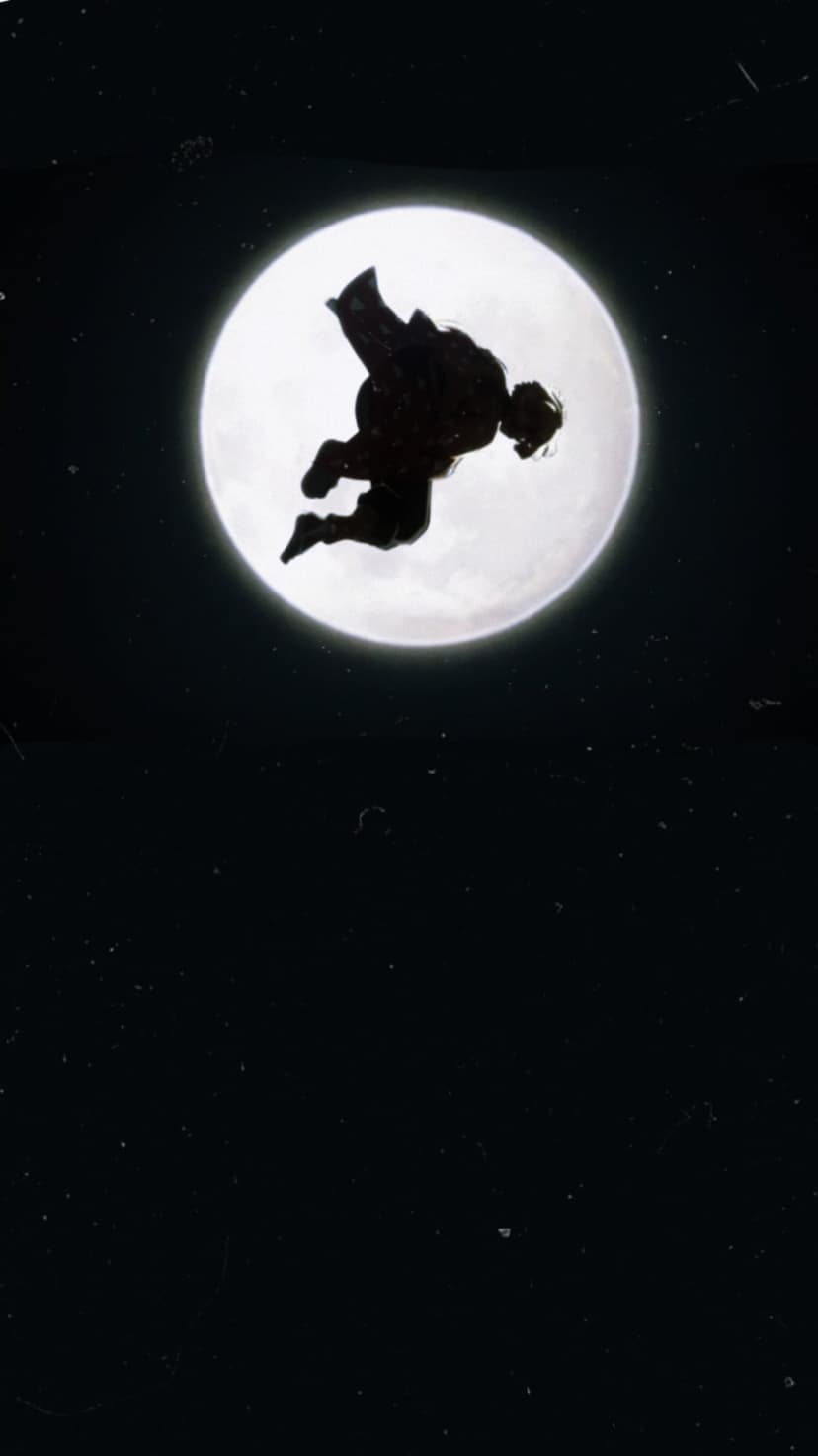 Person leaping in mid-air against a giant glowing white full moon and a starry dark night sky background.