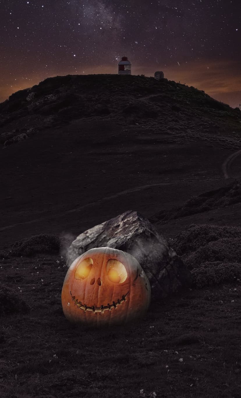 Glowing jack-o'-lantern sits on a rocky ridge under a vivid Milky Way galaxy and starry night sky with a lighthouse.