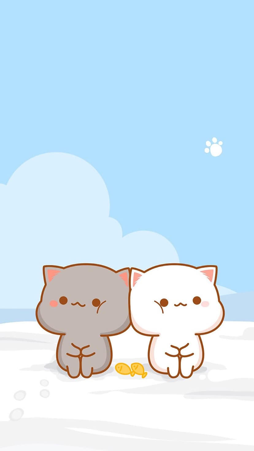 Two fluffy cats, one grey and one white, sit in snow beside a golden fish under a blue sky with a paw cloud.