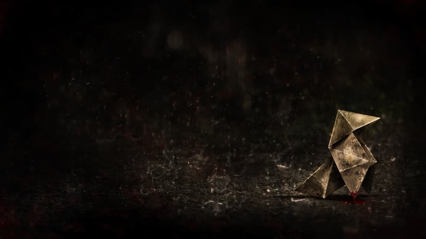 Origami bird figure on wet dark pavement under falling rain with a small red blood droplet at its base.