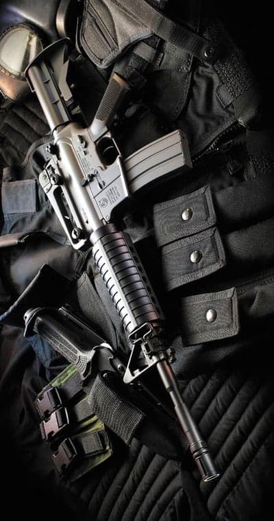 Tactical Rifle and Handgun Gear on Black Vest