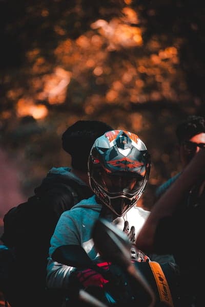 Cinematic Biker in Orange Sunset Haze Phone Wallpaper