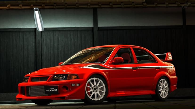 Red Mitsubishi Lancer Evolution VI with white wheels parked inside a dark Japanese-style garage with soft lighting.