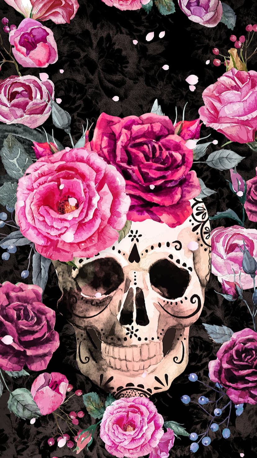 Sugar skull decorated with magenta roses and floral patterns against a dark textured vertical backdrop.
