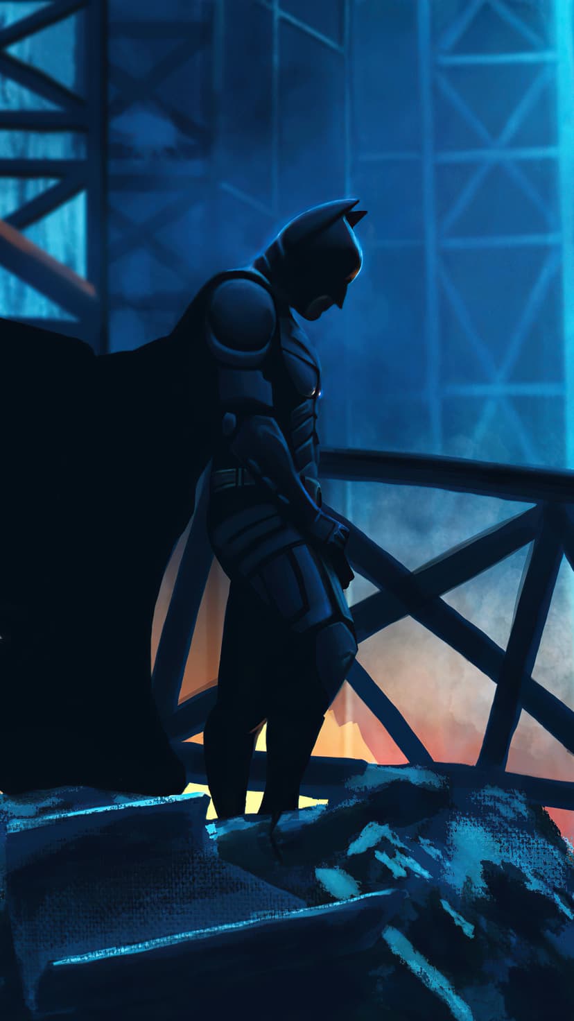 Batman stands in silhouette on a metal bridge overlooking a city illuminated by blue and orange lights.