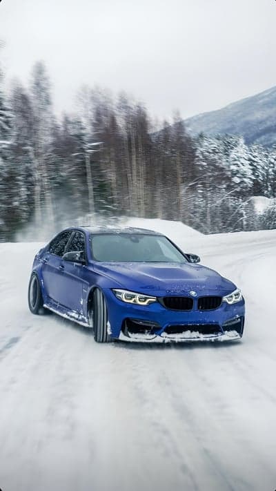 Blue BMW M4 Drifting on Snowy Forest Road