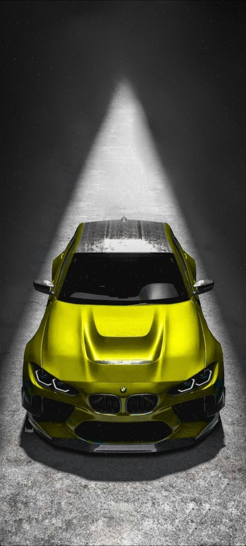 Yellow BMW M car parked on textured asphalt under a focused top-down spotlight against a black background.
