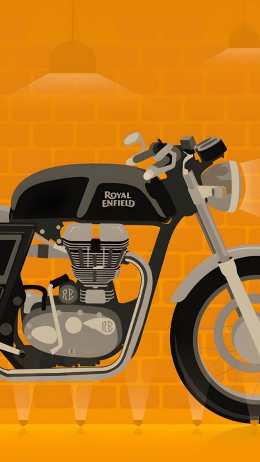 Royal Enfield motorcycle with a chrome engine and black frame parked against a warm orange brick wall.