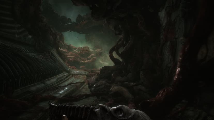Biomechanical organic corridor with fleshy walls, green mist, and a bone-like device in first-person view.