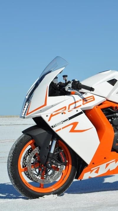 White and orange KTM sportbike in a snowy landscape