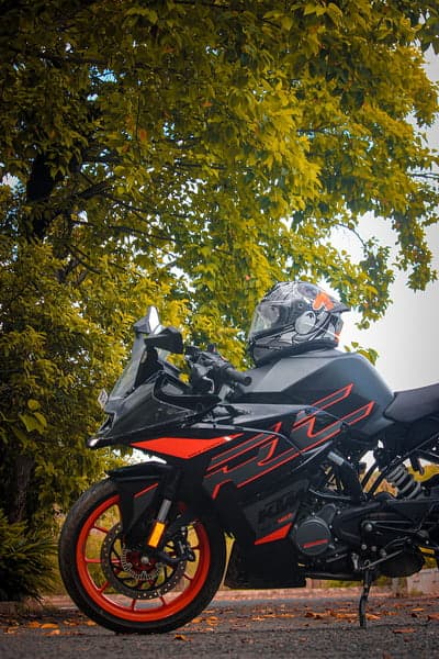 KTM RC Motorcycle parked under a leafy tree