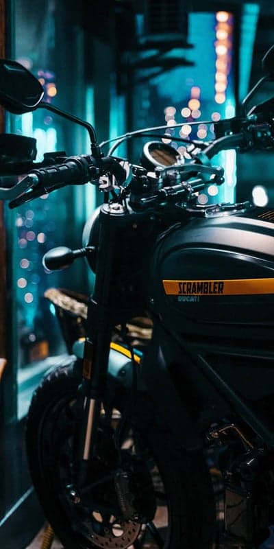 Ducati Scrambler Motorcycle with City Lights Bokeh