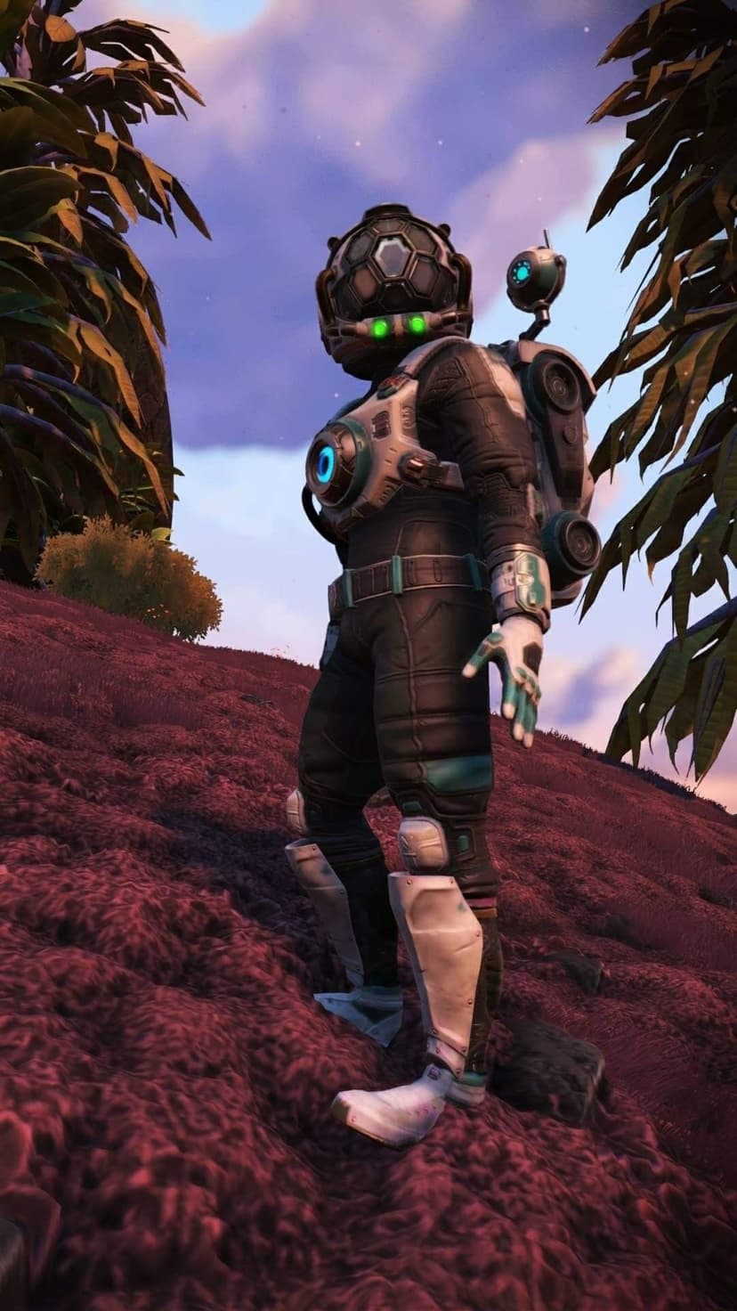 Space explorer in a black suit with glowing green eyes standing on a red planet under a purple sky.