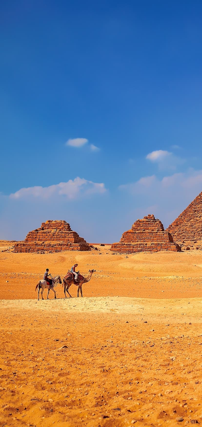 Great Pyramids of Giza rise behind two travelers on a horse and a camel crossing sun-drenched desert dunes.