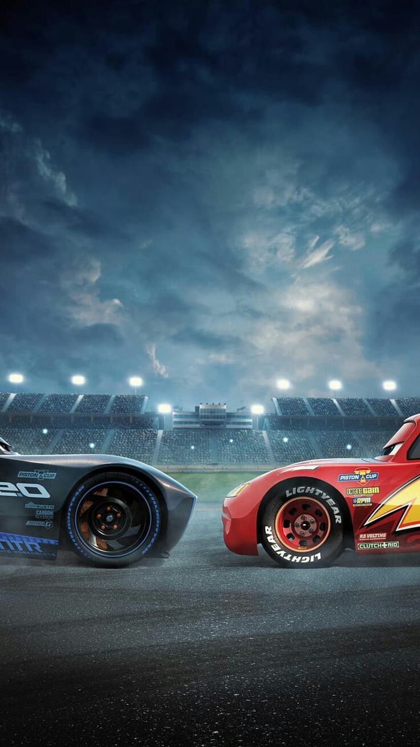 Lightning McQueen and Cruz Ramirez face each other on a dark racetrack under bright stadium lights at night.