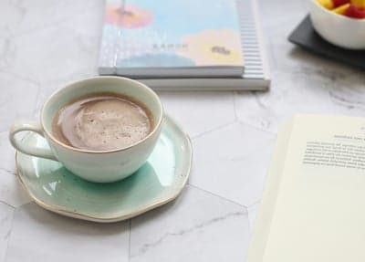 Cozy Hot Chocolate and Books on a Marble Table